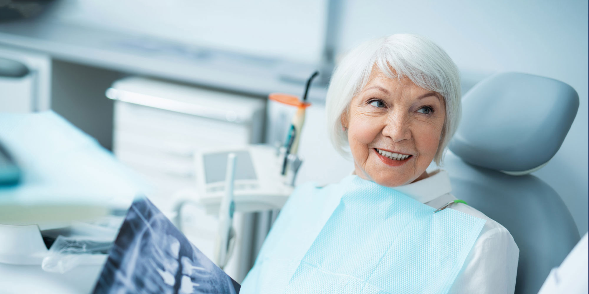 older patient discussing fixed vs removable implant options