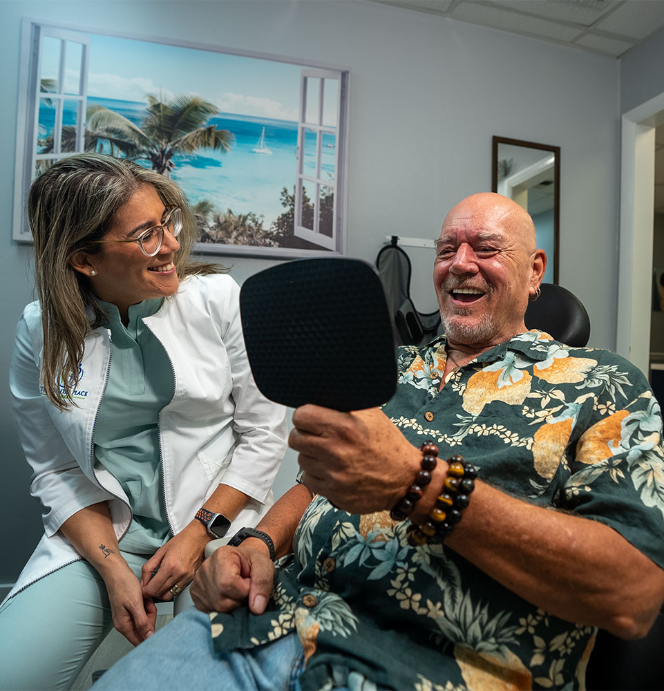 Dr. Franco showing patient results of their teeth after dental procedure