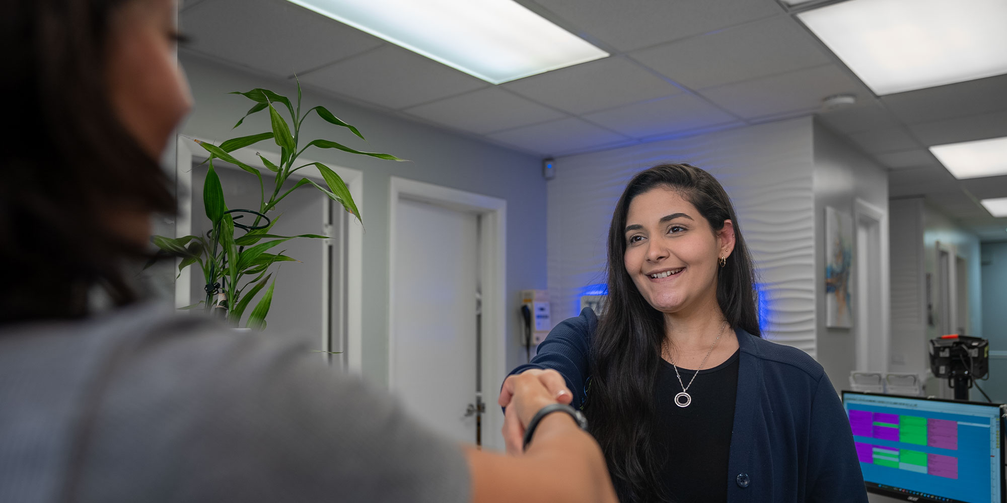 team member shaking patient's hand