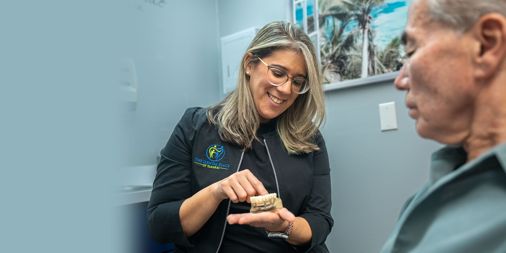 Dr. Franco showing patient a model of teeth